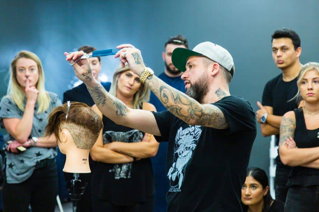 Rory teaching aspiring barbers and stylists the best techniques for cutting hair of all styles 